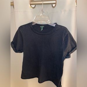 Black t shirt. Sleeves are cuffed